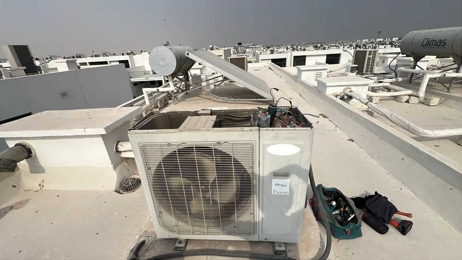 Open rooftop AC unit during inspection at a Dubai property
